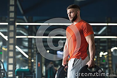 Attractive muscular bodybuilder doing heavy deadlifts in modern fitness center Stock Photo