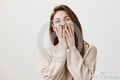 Attractive nail master laughs with her coworkers while there is no clients. Portrait of emotive gorgeous female covering Stock Photo