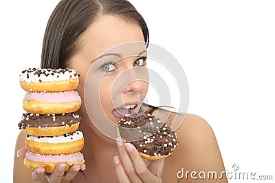 Attractive Natural Happy Young Woman Eating a Pile of Iced Donuts Stock Photo