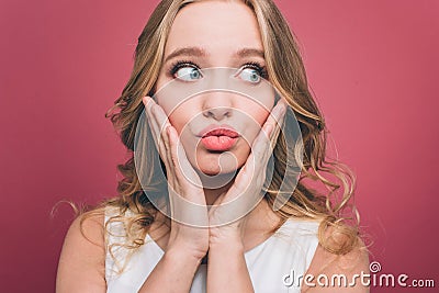 Attractive and nice female person is holding her hands on chicks and looking to the right. She is putting together her Stock Photo