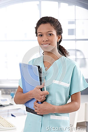 Attractive nurse holding case sheets Stock Photo