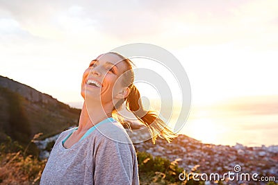 Attractive older woman laughing outdoors during sunset Stock Photo
