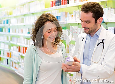 Attractive pharmacist advising a patient Stock Photo