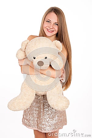 Attractive positive blonde hugging a teddy bear Stock Photo