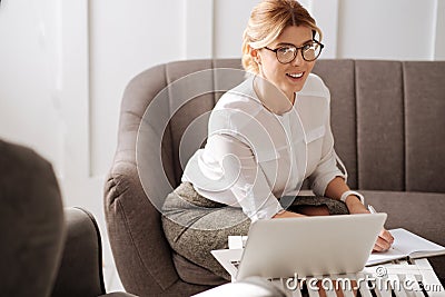 Attractive positive businesswoman enjoying her work Stock Photo