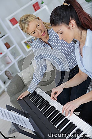 Attractive and positive girl having piano class Stock Photo