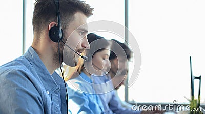 Attractive positive young businesspeople and colleagues in a call center office Stock Photo