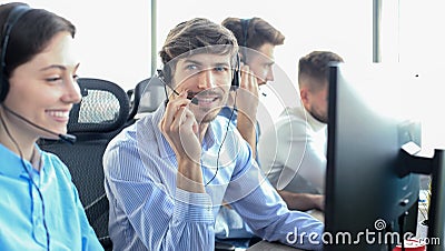 Attractive positive young businesspeople and colleagues in a call center office Stock Photo