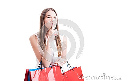 Attractive pretty shopaholic with shopping bags making a silence Stock Photo