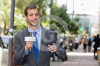 Attractive professional male news reporter wearing Stock Photo