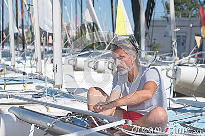 Attractive sailor rigging hobbie-cat before sailing course Stock Photo