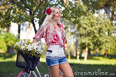 Attractive sexy girl with bicycle in the park Stock Photo