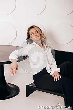 Attractive sexy woman wear business look. Women look sexy and sensual. model wear white shirt and black pants. Stock Photo