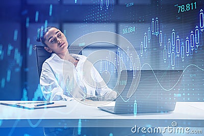 Attractive sleepy businesswoman at desk with glowing candlestick forex chart on blurry office interior background. Stock market Stock Photo