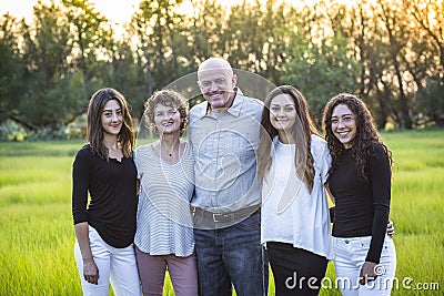 Attractive Smiling diverse family portrait outdoors Stock Photo