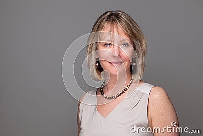 Attractive Smiling Elegant Woman on Grey Stock Photo