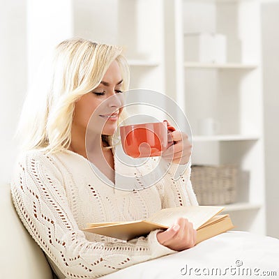 Attractive smiling happy woman reading a book Stock Photo