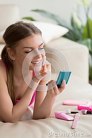 Young woman making simple daily makeup at home Stock Photo
