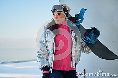 Charming lady with snowboard is posing for photographer Stock Photo