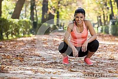 Attractive sport woman in runner sportswear taking a break tired smiling happy and cheerful after running workout Stock Photo