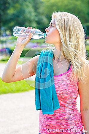 Attractive sporty blond woman drinking water Stock Photo