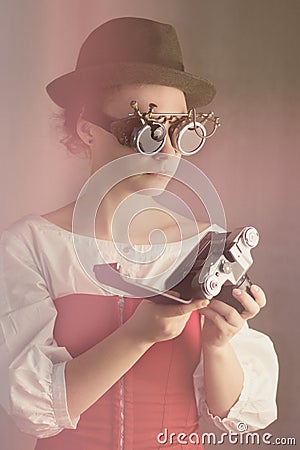 Attractive steampunk girl hold the camera Stock Photo