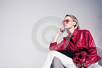 attractive stylish girl posing on armchair for fashion shoot, Stock Photo