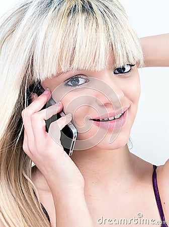 Attractive teen girl smiling while phoning Stock Photo