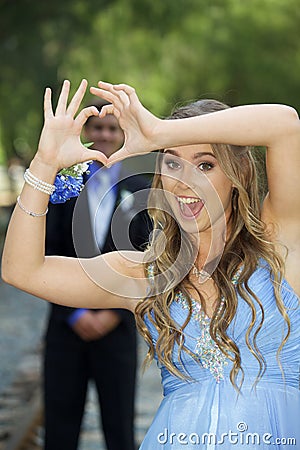 Attractive Teenage Prom Couple Forming Hand Heart Stock Photo