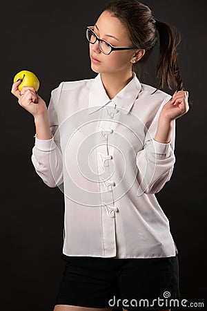 Attractive teenager girl looking an apple Stock Photo