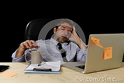 Attractive tired businessman in shirt and tie tired overwhelmed heavy work load exhausted at office Stock Photo