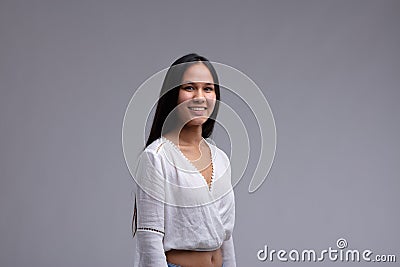 Attractive toung woman with a friendly smile and long dark hair Stock Photo