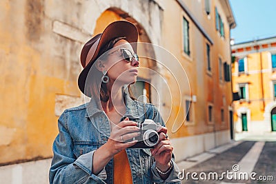 Attractive tourist with a retro camera Stock Photo