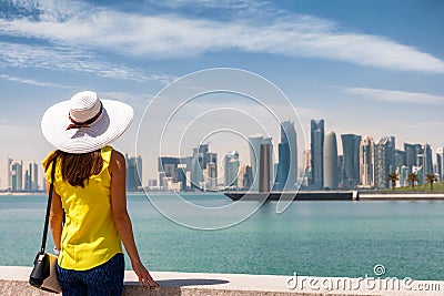 Î¤raveler tourist woman enjoys the view to the urban skyline of Doha, Qatar Editorial Stock Photo