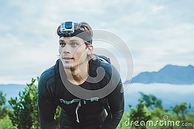 Attractive Traveler vith GoPrO camera on his hand against the Ba Stock Photo