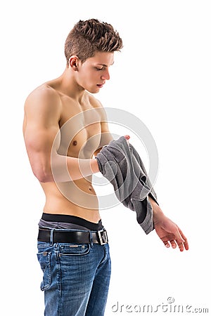 Attractive trendy young man undressing Stock Photo