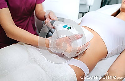 Attractive woman abdomen getting Cool sculpting procedure for body slimming. Cryolipolyse and body contouring treatment, Stock Photo