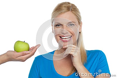 Attractive woman is being offered a green apple Stock Photo
