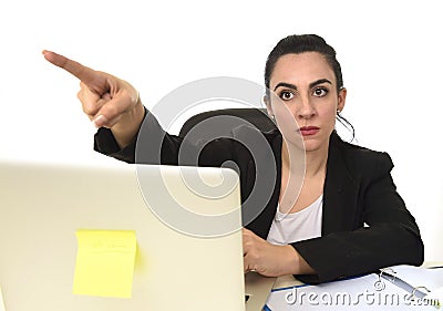 Attractive woman in business suit pointing with finger as if firing an employee Stock Photo