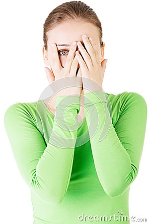 Attractive woman covering her face with both hands. Stock Photo