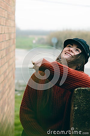 Attractive woman with hat laughing and smiling portrait in a rural scene Stock Photo