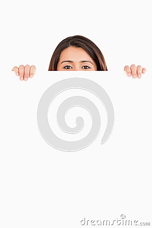 Attractive woman hidding behind a board Stock Photo