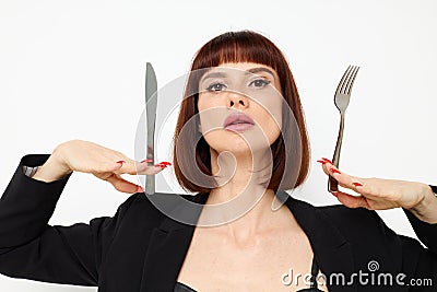 attractive woman knife and fork in hands emotions posing background Stock Photo
