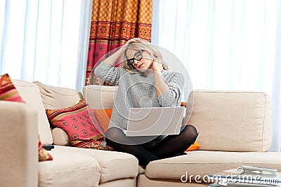 Attractive woman with laptop having neck pain Stock Photo