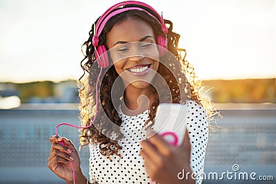 Attractive woman listening to music on her mobile Stock Photo