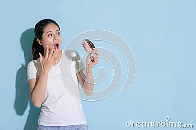 Attractive woman looking at donut sugar food Stock Photo