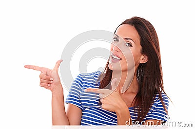 Attractive woman pointing to her right Stock Photo
