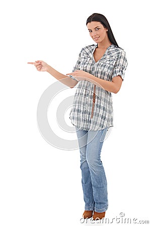 Attractive woman pointing to the right smiling Stock Photo