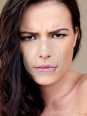 Attractive woman with a puzzled frown Stock Photo