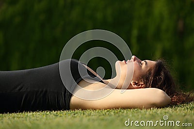 Attractive woman relaxed lying on the grass Stock Photo